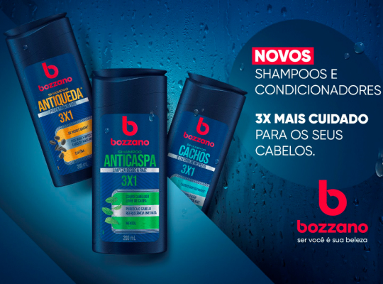 Imagem de divulgao dos novos shampoos e condicionadores Bozzano. Trs embalagens dos novos produtos esto posicionadas em um fundo azul-escuro ao lado do logo da marca e slogan do lanamento.